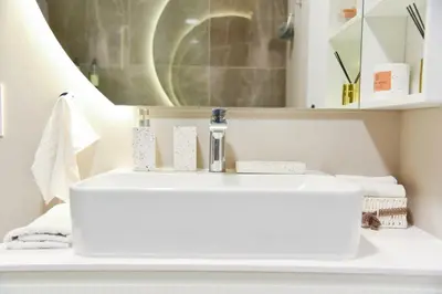 a bathroom with a white sink and a mirror at Casa Novi Dorcol Belgrade in Belgrade