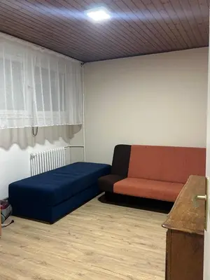 a living room with a blue and red couch at Apartman Riven in Borča