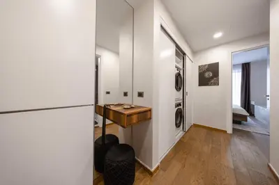 a laundry room with a table and a washing machine at Casa Novi Dorcol Belgrade 2 in Belgrade