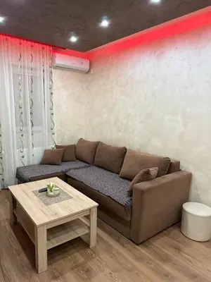 a living room with a couch and a table at Perisic Apartman Obrenovac, sa parkingom in Obrenovac