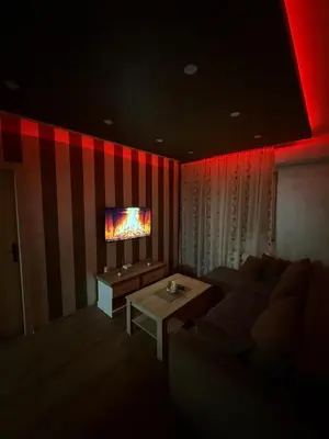 a living room with a couch and a tv at Perisic Apartman Obrenovac, sa parkingom in Obrenovac