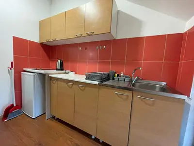 a small kitchen with a sink and a counter top at Bellmatini 07 in Tošin Bunar