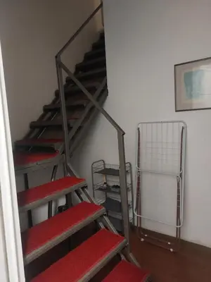 a set of stairs with red seats in a room at Bellmatini 07 in Tošin Bunar