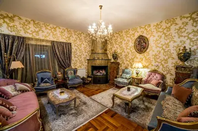 a living room with furniture and a fireplace at Alrawda Resort in Risti°i