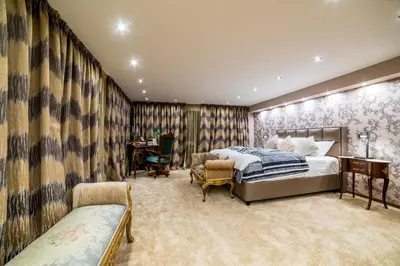 a bedroom with a bed and a desk in it at Alrawda Resort in Risti°i