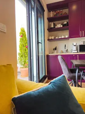 a living room with a yellow couch and a table at Sky Terrace Belgrade in Belgrade