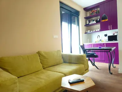 a living room with a couch and a table at Sky Terrace Belgrade in Belgrade