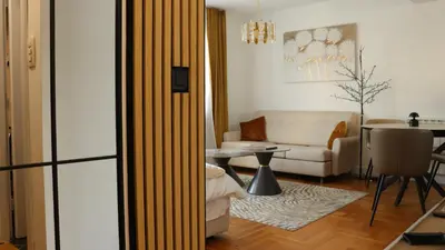 a living room with a couch and a table at Mocha Belgrade Apartment in Belgrade