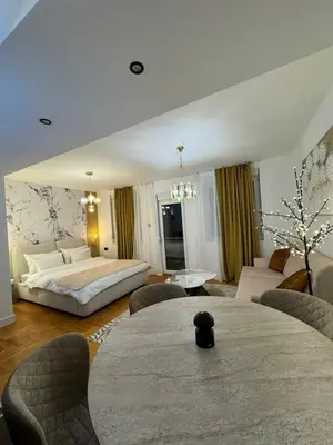 a bedroom with a bed and a living room at Mocha Belgrade Apartment in Belgrade