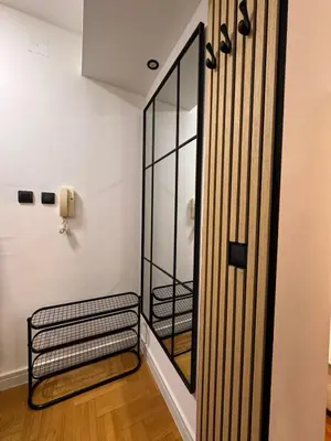 a hallway with a glass door and a stair case at Mocha Belgrade Apartment in Belgrade
