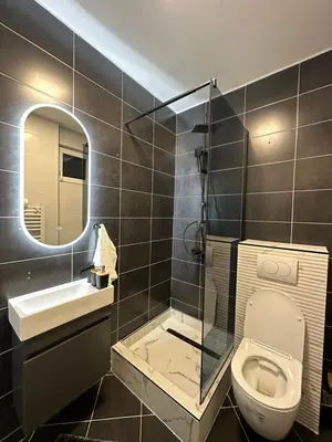 a bathroom with a toilet and a sink and a mirror at Mocha Belgrade Apartment in Belgrade