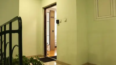a hallway with a door leading into a room at Mocha Belgrade Apartment in Belgrade