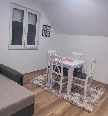 a white table and chairs in a living room at Buku Hill in Arandjelovac