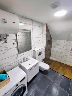 a white bathroom with a sink and a toilet at Buku Hill in Arandjelovac