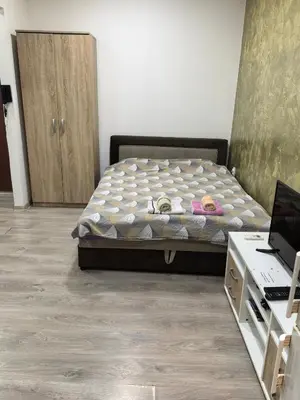 a bedroom with a bed and a desk with a laptop at Belgrade Skadarlija Apartment - City center in Belgrade