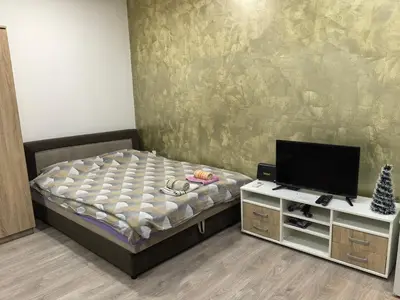 a small bedroom with a bed and a tv at Belgrade Skadarlija Apartment - City center in Belgrade