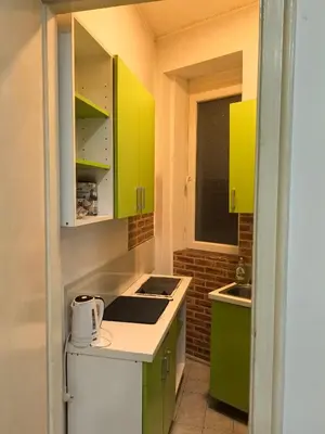 a small kitchen with green cabinets and a sink at Belgrade Skadarlija Apartment - City center in Belgrade