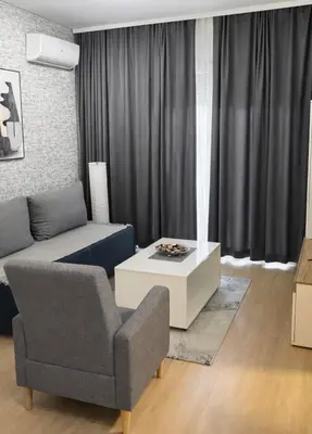 a living room with a couch and a chair at Boost Stay Apartment 1 in Belgrade