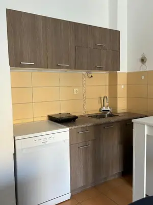 a kitchen with wooden cabinets and a sink at Boost Stay Apartment 1 in Belgrade