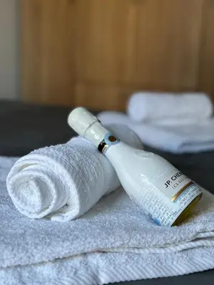 a bottle of wine sitting on top of a towel at Boost Stay Apartment 1 in Belgrade