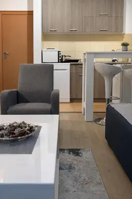 a living room with a chair and a table at Boost Stay Apartment 1 in Belgrade