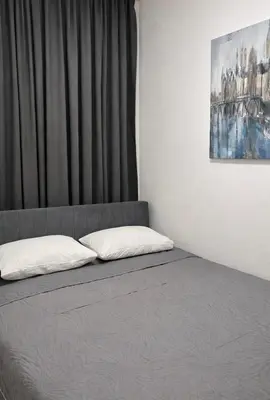 a bed with two pillows on it in a room at Boost Stay Apartment 1 in Belgrade