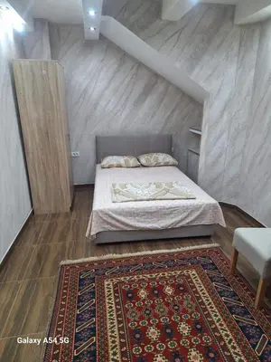 a small bedroom with a bed and a rug at Dream 7 in Belgrade