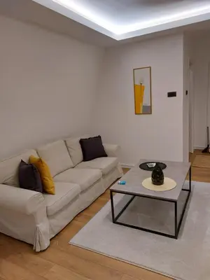 a living room with a couch and a table at Fiore in Belgrade