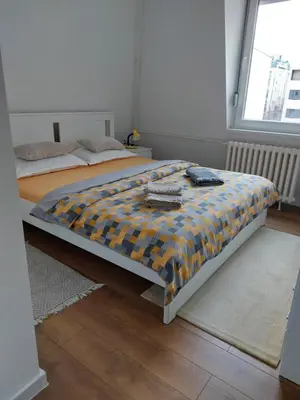 a bedroom with a bed with a comforter on it at Fiore in Belgrade