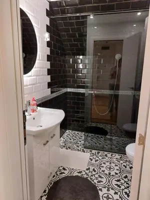 a black and white bathroom with a sink and a shower at Fiore in Belgrade