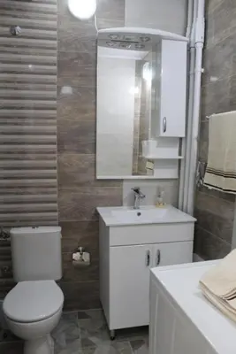 a bathroom with a toilet and a sink and a mirror at TenMinutesToCenter Apartment in Belgrade
