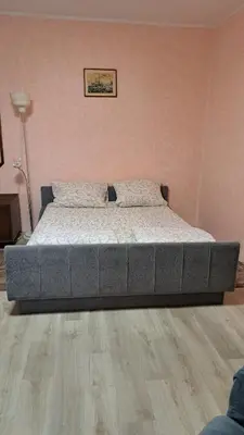a large bed in a bedroom with a wooden floor at Industrial 29N in Belgrade