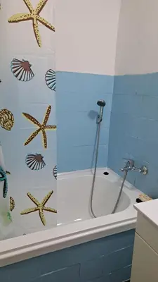 a bathroom with a bath tub with stars on the wall at Industrial 29N in Belgrade