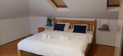 a bedroom with a white bed with blue pillows at Naru in Belgrade