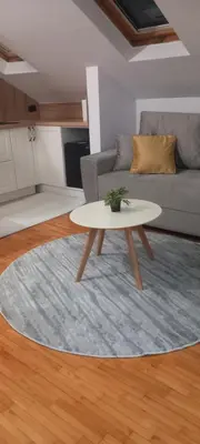 a living room with a table and a couch at Naru in Belgrade