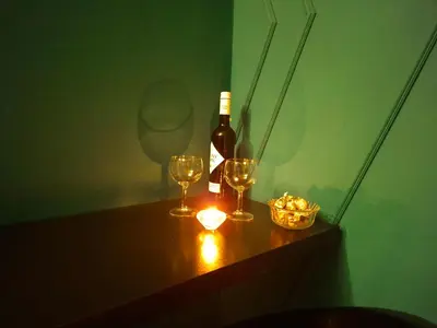 a bottle of wine and two glasses on a table at Apartman Hram in Belgrade