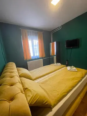 a large yellow bed in a green bedroom at Apartman Hram in Belgrade