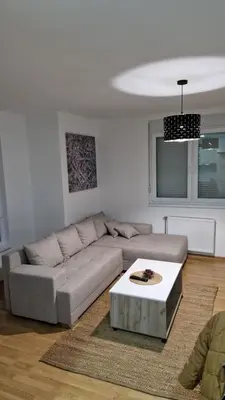 a living room with a couch and a coffee table at Finans2 in Ruma