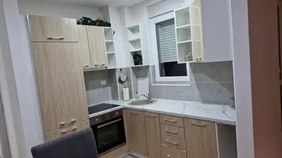 a small kitchen with a sink and a window at Finans2 in Ruma
