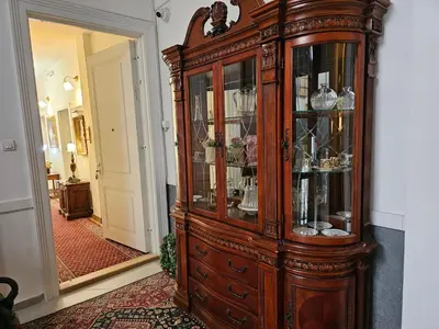 a large wooden cabinet with glass doors in a hallway at Belgrade Luxury Suite 17 in Belgrade