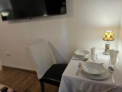 a table with two plates and a lamp on it at Belgrade Luxury Suite 17 in Belgrade