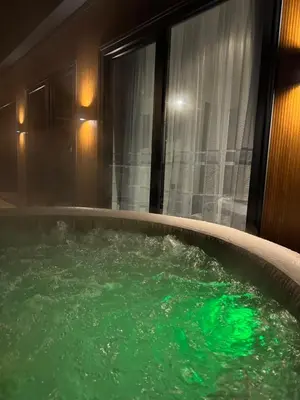 a hot tub with green water in a room at Elysium Garden in Belgrade