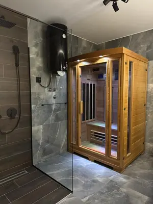 a bathroom with a shower with a wooden cabinet at Elysium Garden in Belgrade