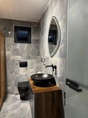 a bathroom with a black sink and a mirror at Elysium Garden in Belgrade