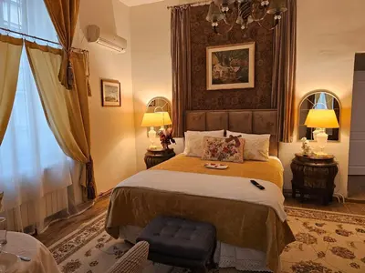 a bedroom with a large bed and two lamps at Belgrade Luxury Suite 19 in Belgrade