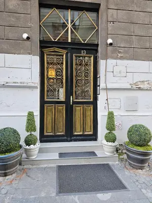 a door on a house with potted plants in front at Belgrade Luxury Suite 19 in Belgrade