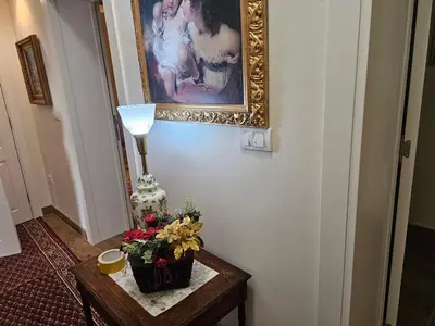 a table with a lamp and a painting on the wall at Belgrade Luxury Suite 19 in Belgrade