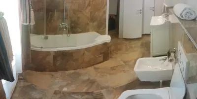 a bathroom with a sink and a tub and a toilet at Belgrade Luxury Suite 19 in Belgrade