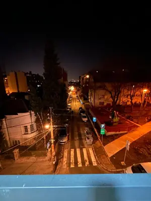 a city street at night with cars parked on the street at Krfska Lux by Magenta in Belgrade