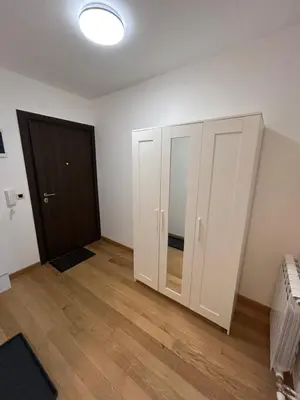 an empty room with white cabinets and a door at Krfska Lux by Magenta in Belgrade